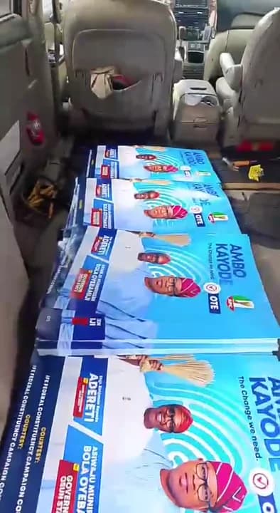 Stacks of printed full-colour political campaign posters bundled in a transport vehicle in Lagos.