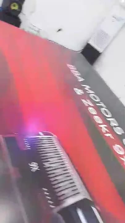 Large red and black BBA Motors and Zeekr grand opening printed display graphic laid out on a workshop floor.