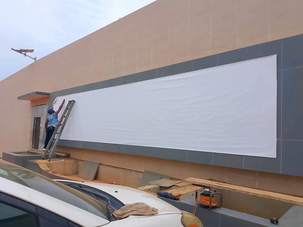 Surveying and preparing a commercial building facade before signage installation