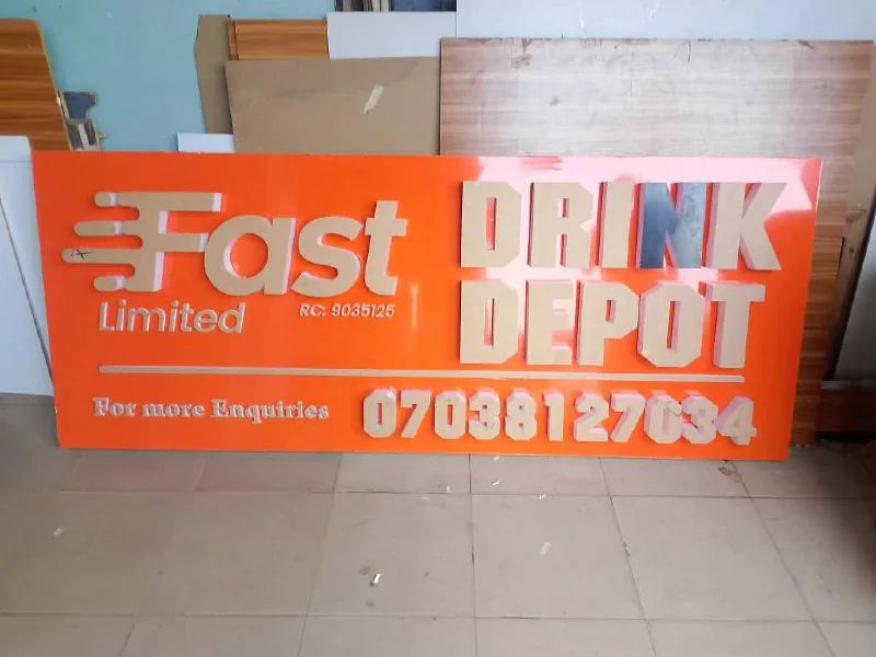 Completed orange Fast Limited Drink Depot fascia sign with 3D acrylic letters in the workshop.