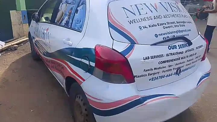 Fully branded white Toyota Yaris hatchback with New Vision Wellness wrap graphics and window film.
