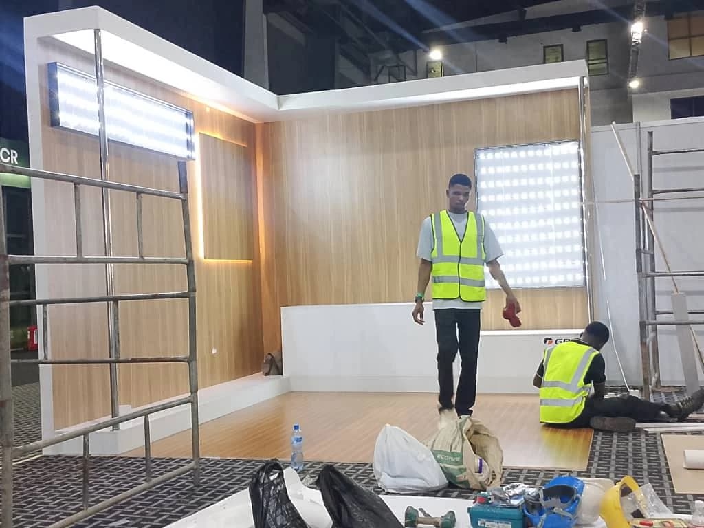 Adash fabrication crew assembling an illuminated exhibition booth and custom cladding