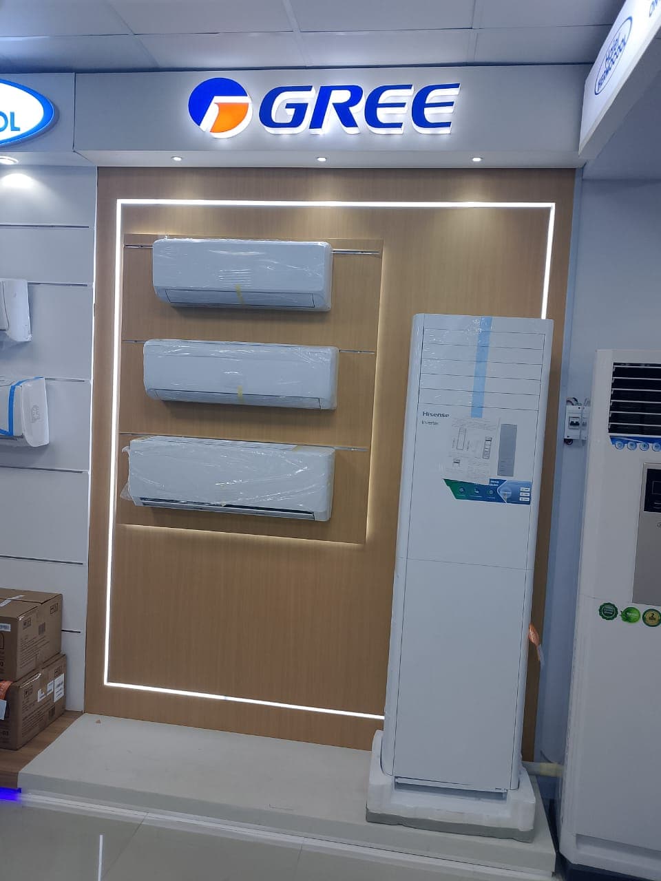 Fabricated white and blue GREE commercial air conditioning display plinth on a showroom floor.