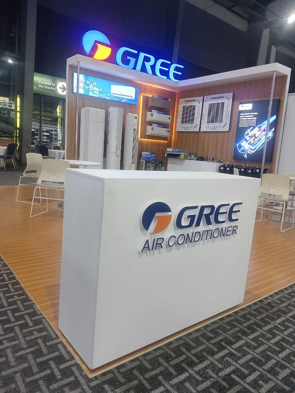 Suite of white modular GREE commercial display plinths in a retail showroom.