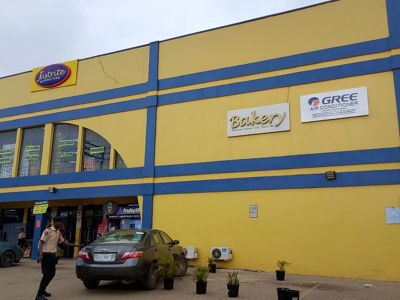 Justrite Superstore yellow and blue building facade featuring fabricated bakery signage and dealer panels.