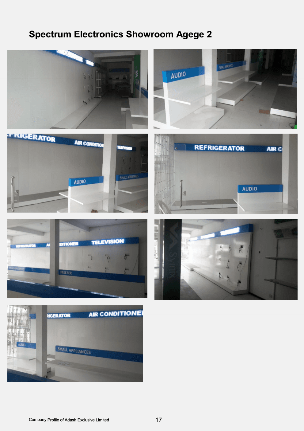 Modular white and blue category display bays with illuminated headers in Spectrum Electronics showroom.